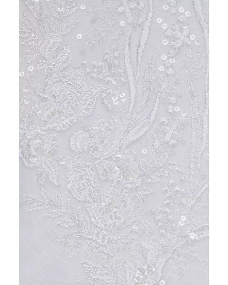 White lace fabric with delicate floral embroidery and sequin embellishments showing wedding dress detail — Oleg Cassini | Endless UAE