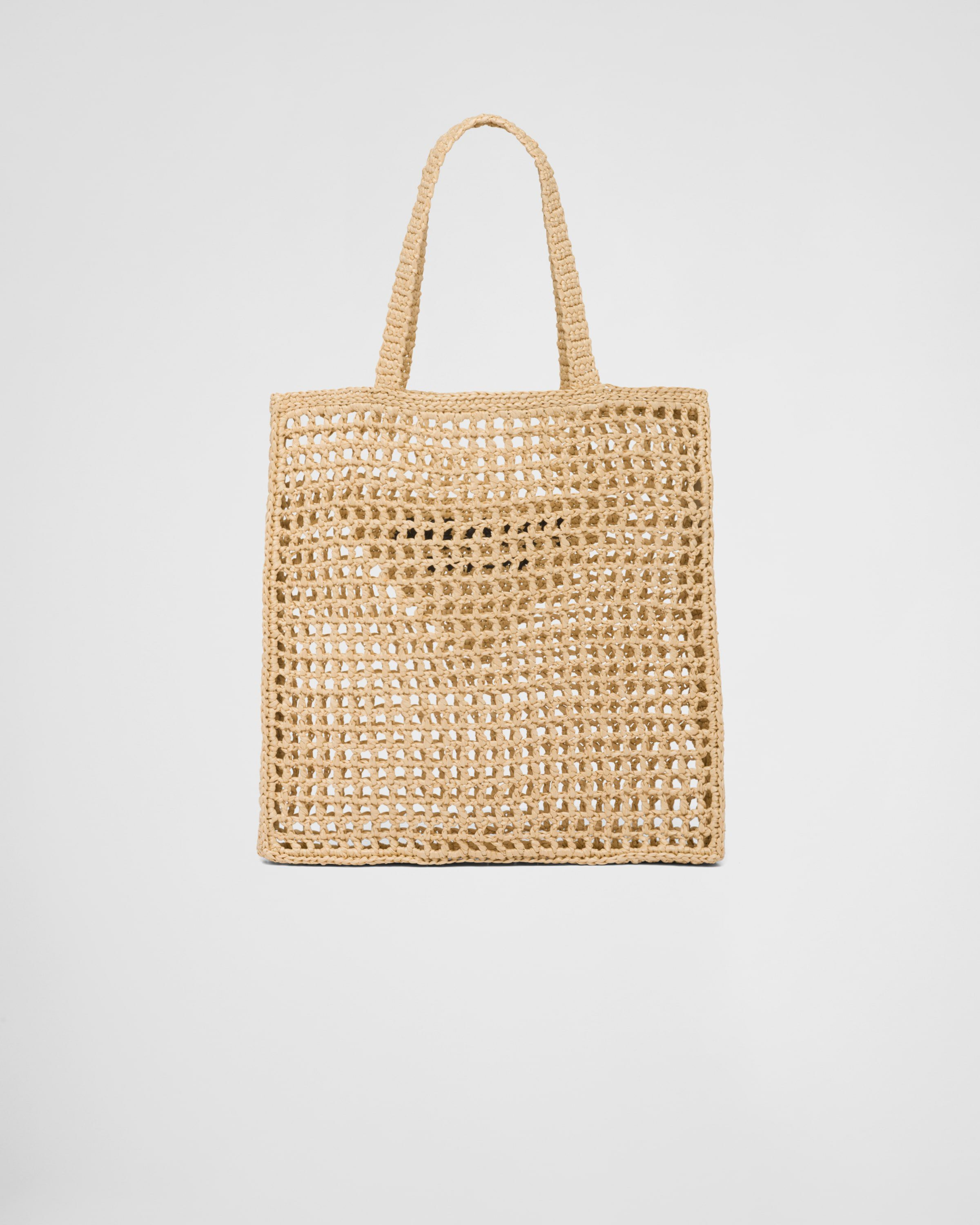 Natural raffia woven tote bag with open crochet pattern and triangle logo detail — Prada | Endless UAE