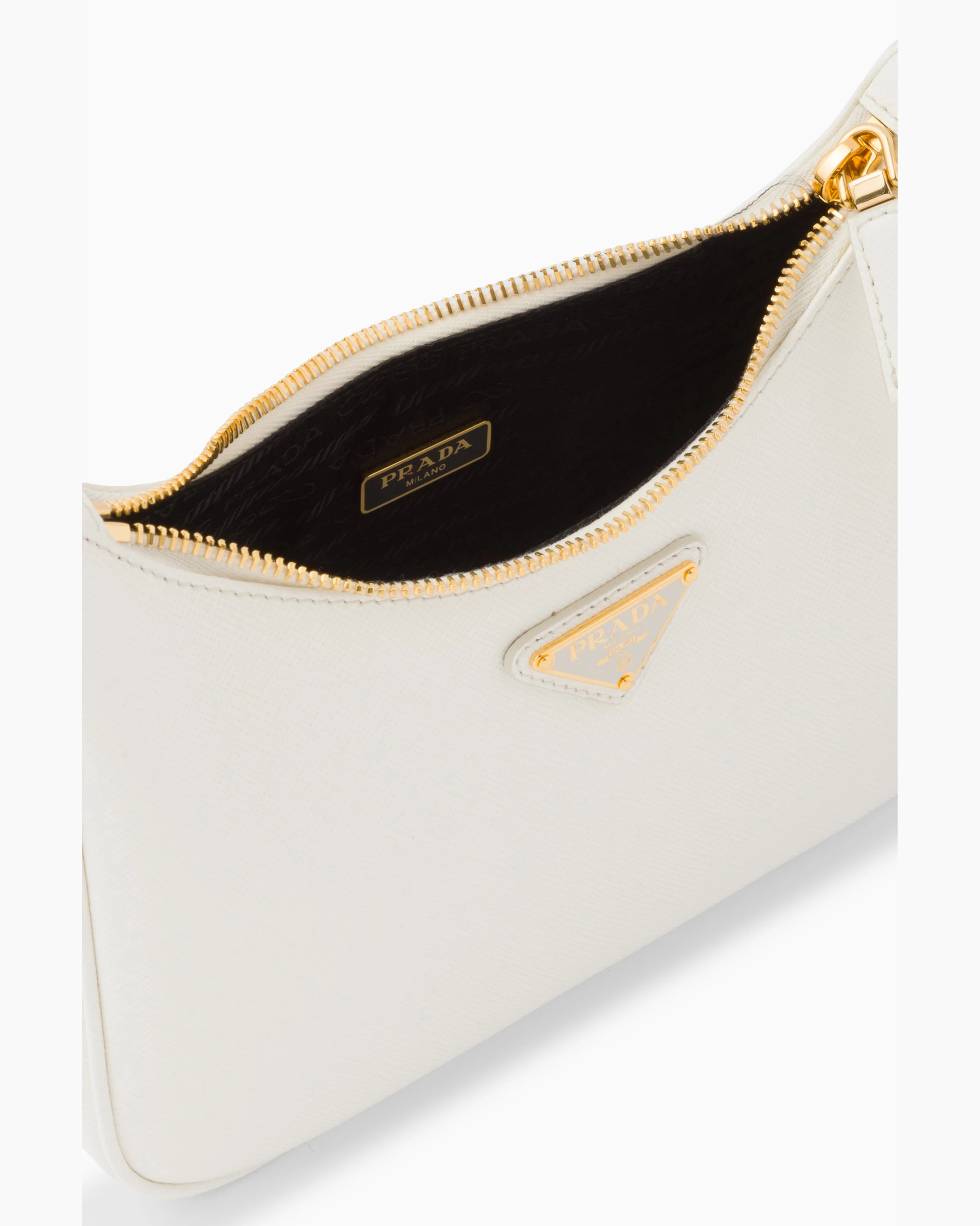 White Saffiano leather mini bag with gold zipper and triangular logo plaque, black interior lining shown — Prada | Endless UAE