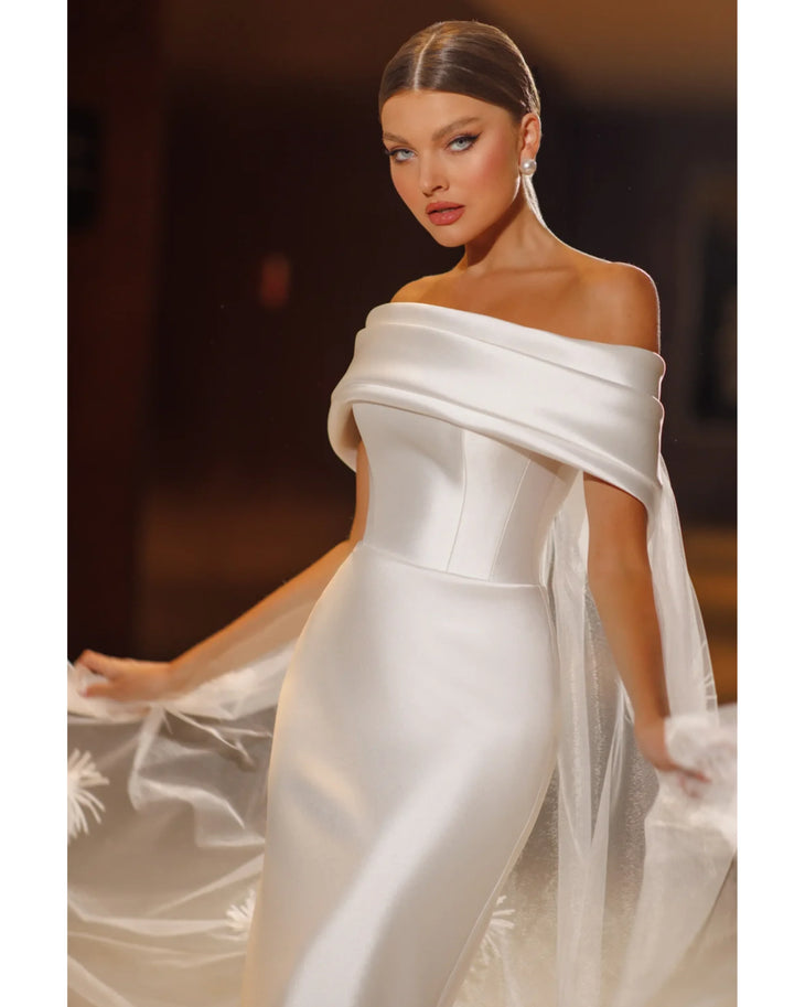 Elegant white off-shoulder satin gown with draped sleeves and structured bodice — Mary Trufel Boutique | Endless UAE
