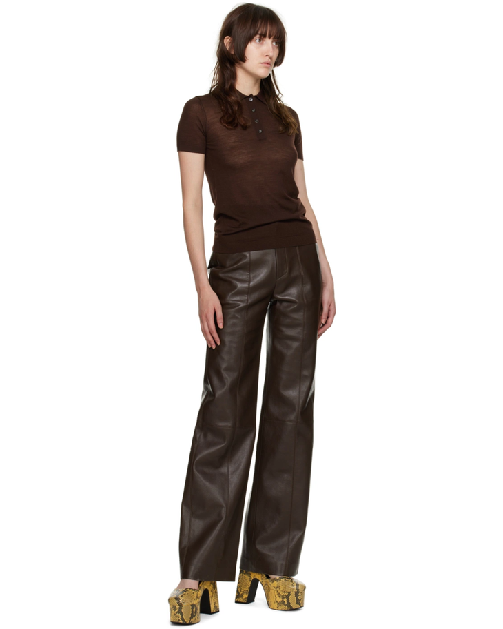 Wide-leg brown vegan leather pants with high waist and relaxed fit, styled with brown polo and snake-print heels — Nanushka | Endless UAE