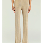 Woman wearing a beige metallic knit top and matching trousers holding a small handbag — SER.O.YA | Endless UAE