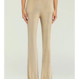 Woman wearing a beige metallic knit top and matching trousers holding a small handbag — SER.O.YA | Endless UAE
