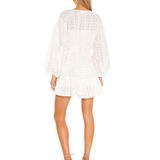 White eyelet mini dress with long blouson sleeves and tiered skirt shown from back — Significant Other | Endless UAE