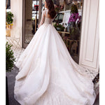 Elegant white wedding dress with beaded lace bodice and flowing ball gown skirt — Mar©a Anette | Endless UAE
