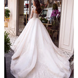 Elegant white wedding dress with beaded lace bodice and flowing ball gown skirt — Mar©a Anette | Endless UAE