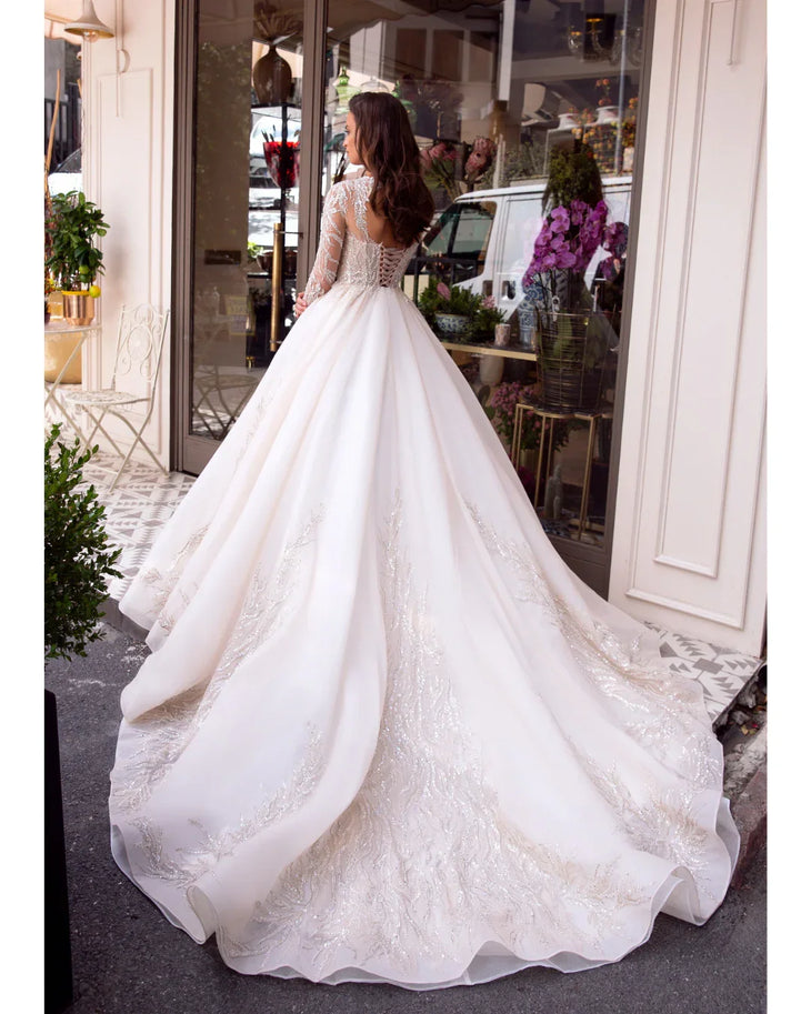 Elegant white wedding dress with beaded lace bodice and flowing ball gown skirt — Mar©a Anette | Endless UAE