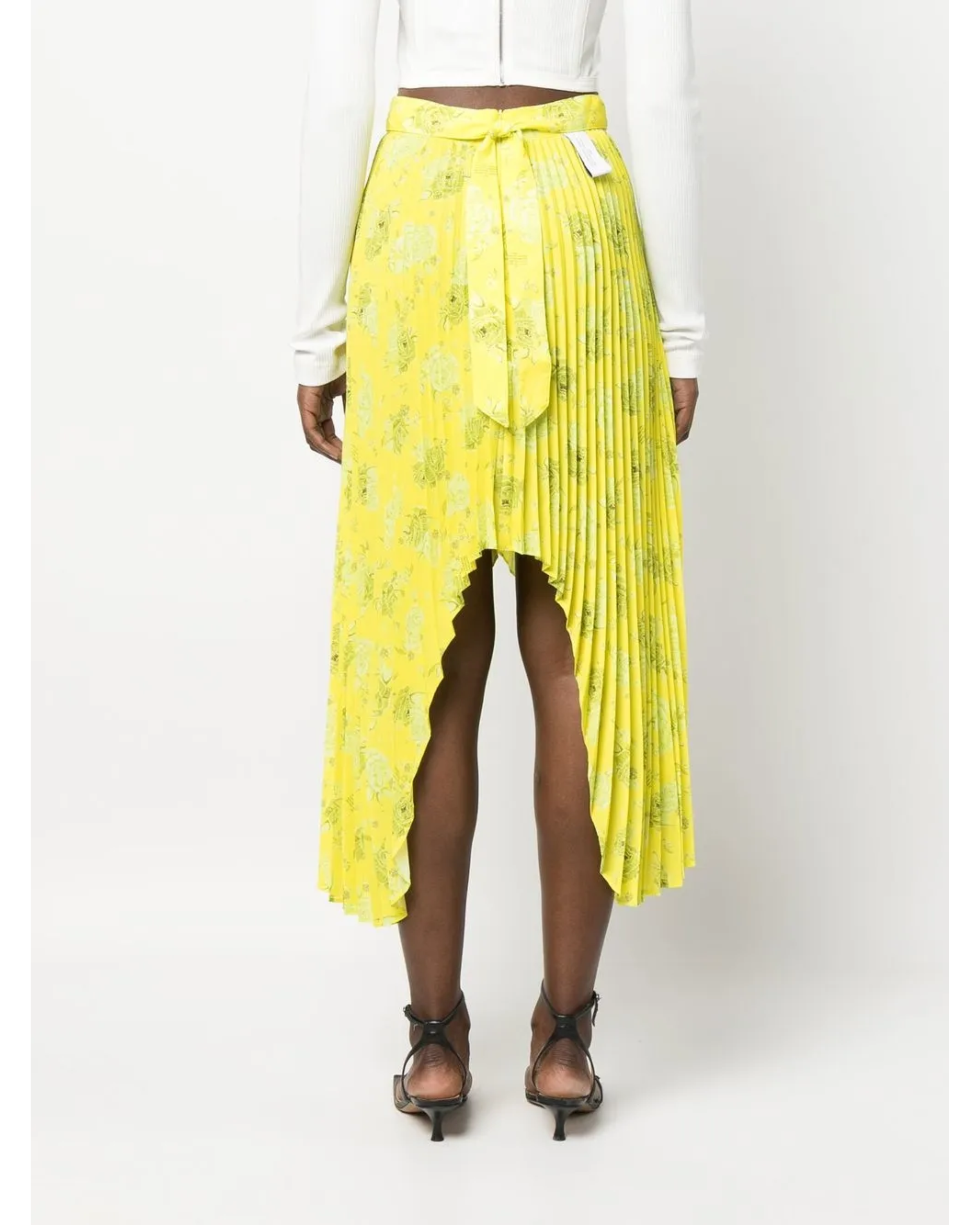 Bright yellow pleated midi skirt with asymmetric high-low hemline and tie waist detail, shown from back — Rokh | Endless UAE