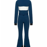 Woman wearing navy and white colorblocked ski jumpsuit with belt and black boots — Cordova | Endless UAE
