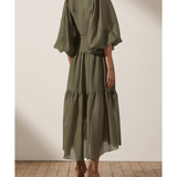 Olive green midi dress with high neck, balloon sleeves, tiered skirt and textured fabric, shown from back — Shona Joy | Endless UAE