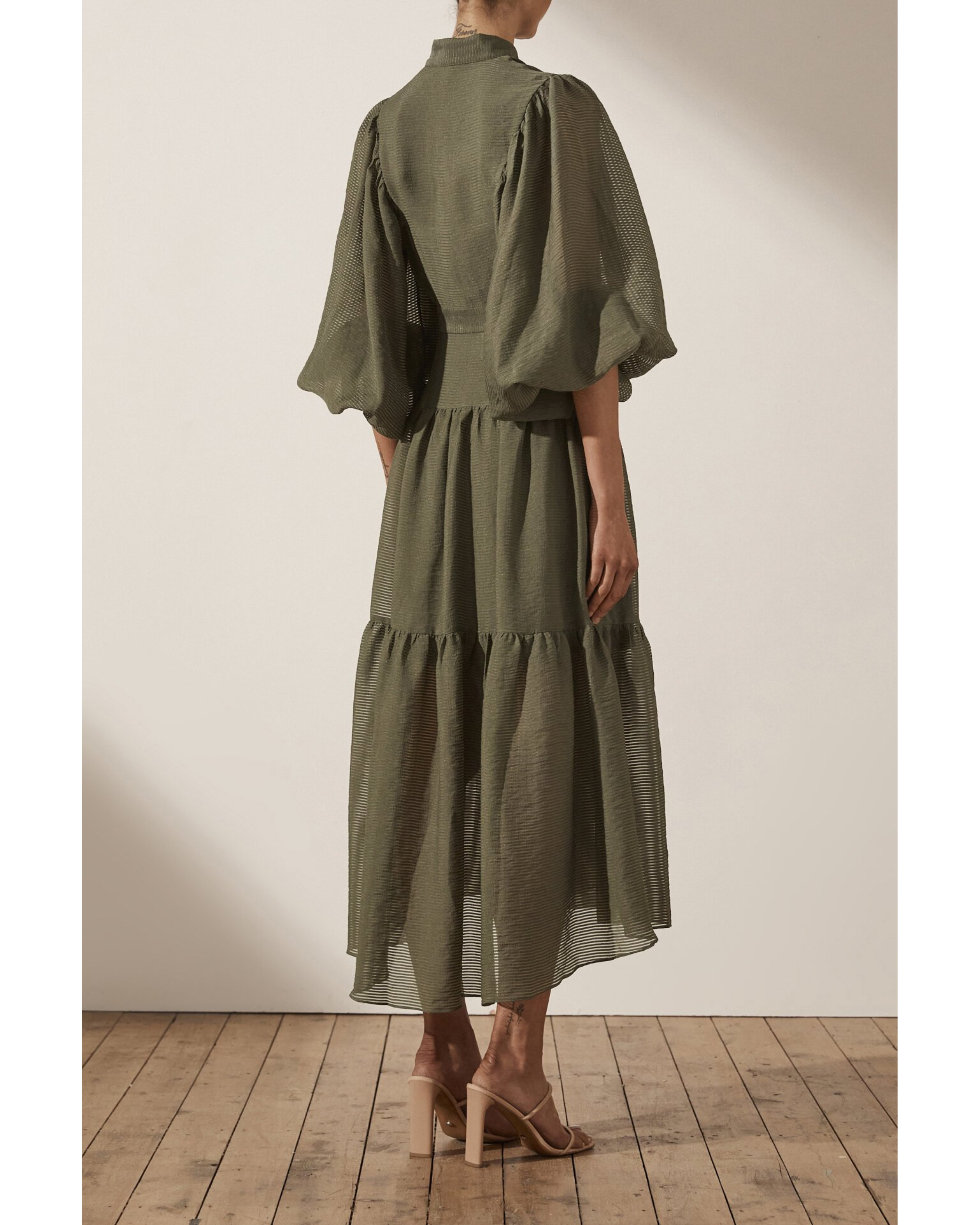 Olive green midi dress with high neck, balloon sleeves, tiered skirt and textured fabric, shown from back — Shona Joy | Endless UAE