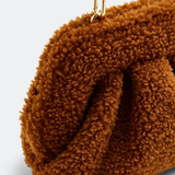 Gea Clutch in caramel brown textured fabric held in hand — TheMoire | Endless UAE