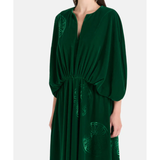 Woman wearing a forest green silk velvet maxi dress with draped sleeves and embroidered details — Themis-Z | Endless UAE
