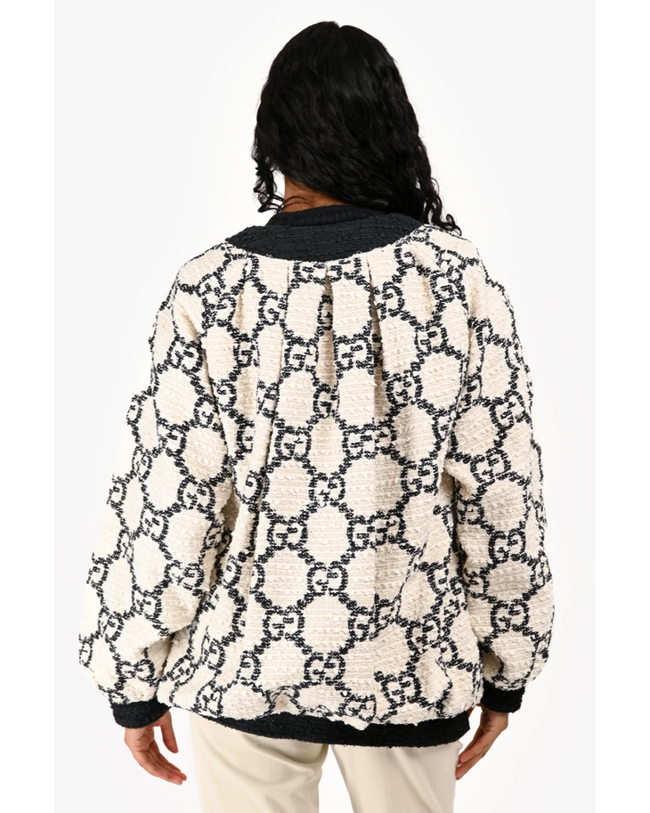 Cream fleece bomber jacket with black GG monogram pattern and black ribbed collar and cuffs, shown from back — Gucci | Endless UAE