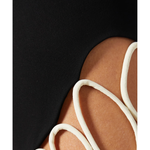 Black mini skirt with white wavy trim detail on leg — Nafsika Skourti | Endless UAE