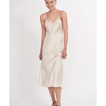 Woman wearing cream spaghetti strap slip dress with black strappy heels — Silk Laundry | Endless UAE