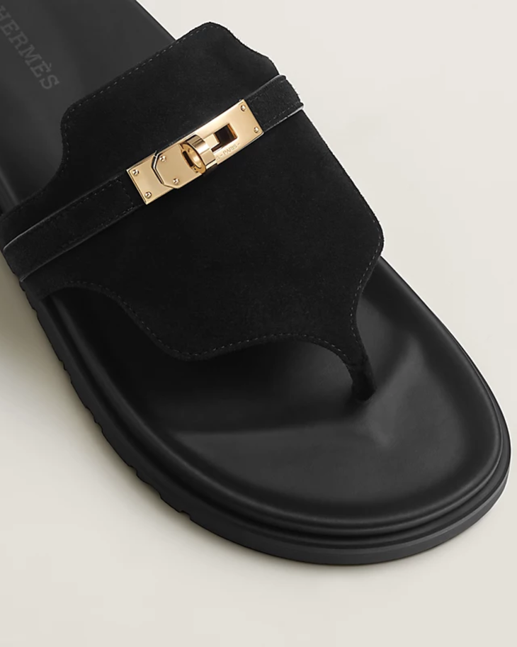 Black suede slide sandal with gold-tone Kelly lock hardware and platform sole — Hermes | Endless UAE