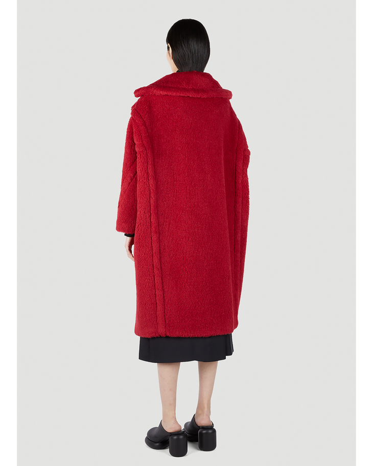 Woman wearing oversized red teddy bear textured coat with collar, viewed from back, paired with black midi skirt and shoes — Max Mara | Endless UAE
