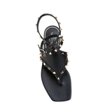 Black leather thong sandals with gold pyramid studs and ankle strap, viewed from above — Valentino Garavani | Endless UAE