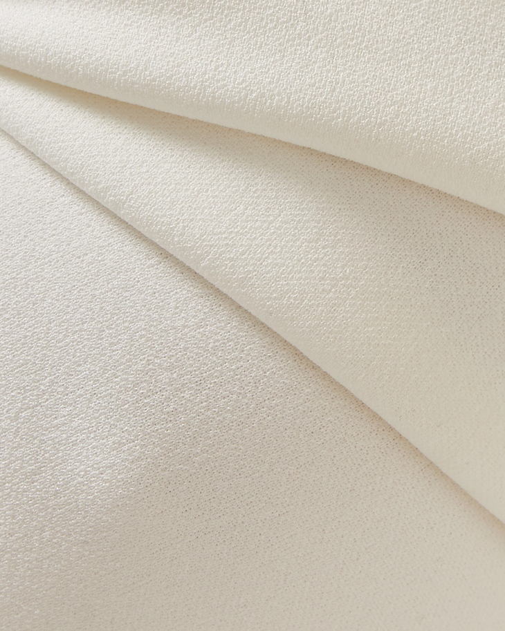 Elegant cream textured fabric with subtle sheen draped in soft folds showing luxurious material detail — Misha | Endless UAE