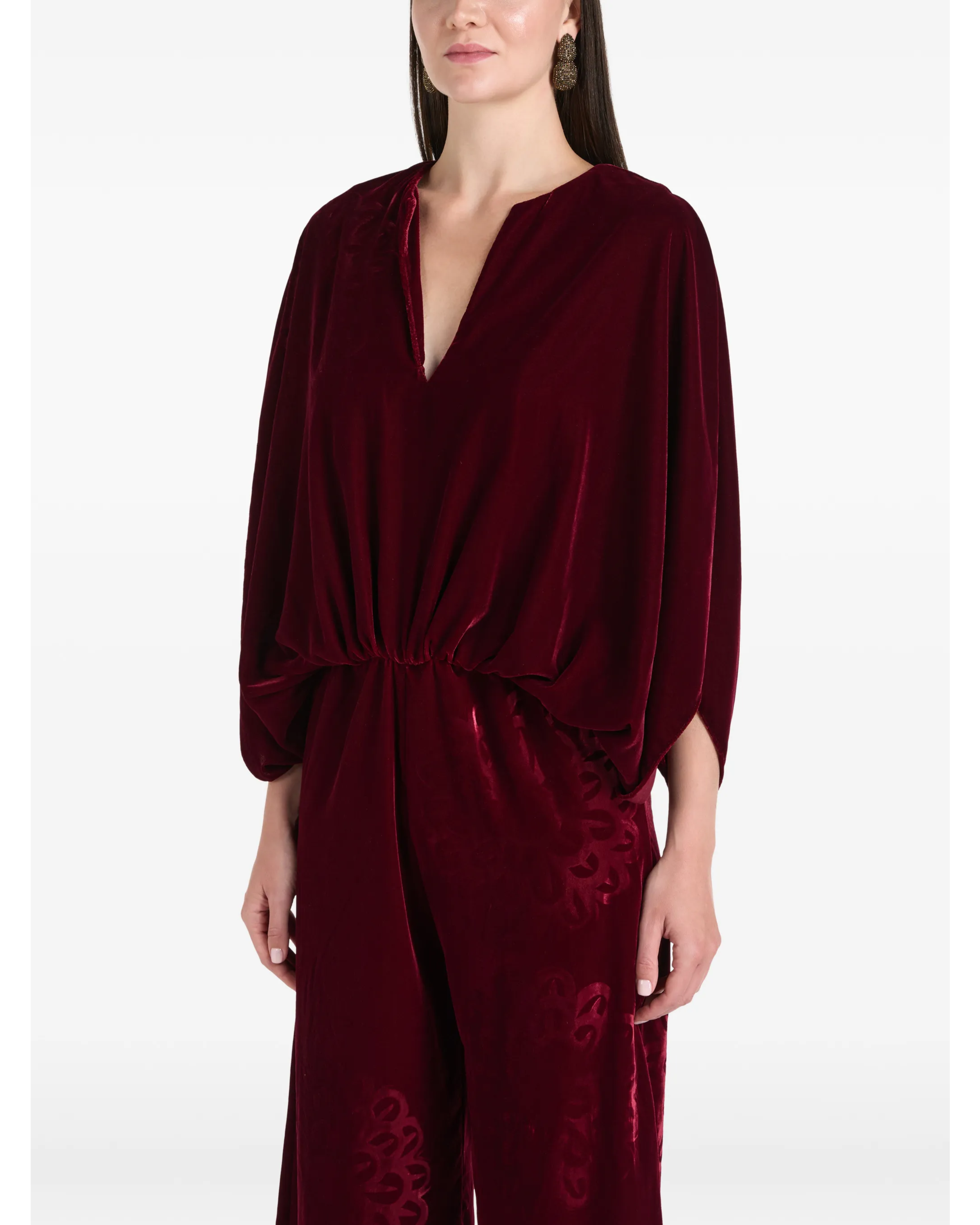 Woman wearing burgundy silk velvet jumpsuit with ornamental detailing and wide legs — Themis-Z | Endless UAE