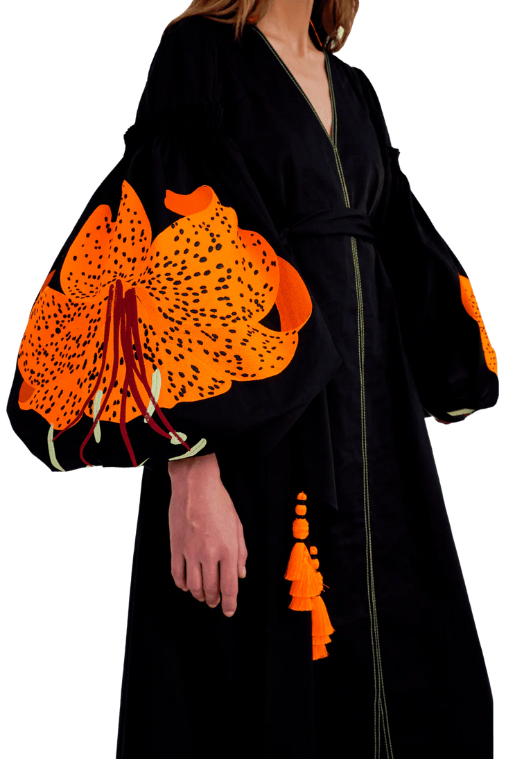 Black cotton caftan with vibrant orange tiger lily embroidery on billowing sleeves and decorative tassel tie — Yuliya Magdych | Endless UAE