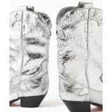 Silver crackled leather western-style cowboy boot with black heel and decorative stitching — Schutz | Endless UAE