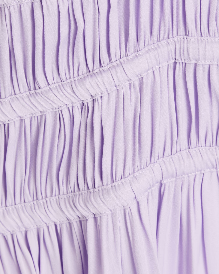 Lavender ruffle tiered dress detail with gathered fabric layers and stitching — Endless | Endless UAE