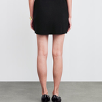 Back view of woman wearing black knitted mini skirt with black kitten heels — Claudie Pierlot | Endless UAE