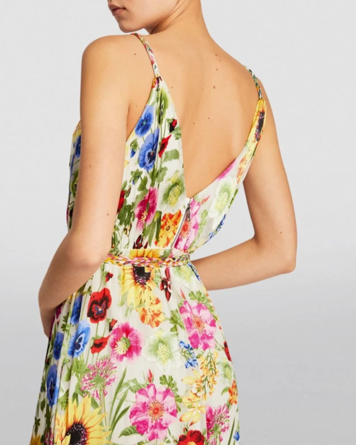 Woman wearing a colorful floral faux wrap maxi dress with sunflowers and pink flowers — Alice & Olivia | Endless UAE
