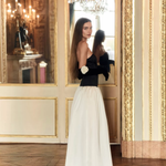 Woman wearing black and white off-shoulder Parisienne Maxi Dress in ornate palace room — Lichi | Endless UAE
