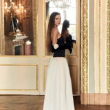 Woman wearing black and white off-shoulder Parisienne Maxi Dress in ornate palace room — Lichi | Endless UAE