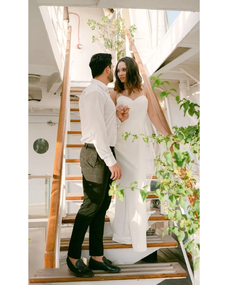 Bride in white convertible wedding dress with floral embellishments and flowing train — Dressarte Paris | Endless UAE