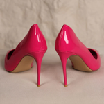 Bright pink patent leather stiletto pumps with pointed toes and high heels on neutral background — Subashini Heels | Endless UAE