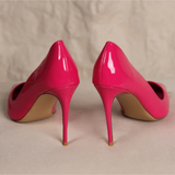 Bright pink patent leather stiletto pumps with pointed toes and high heels on neutral background — Subashini Heels | Endless UAE