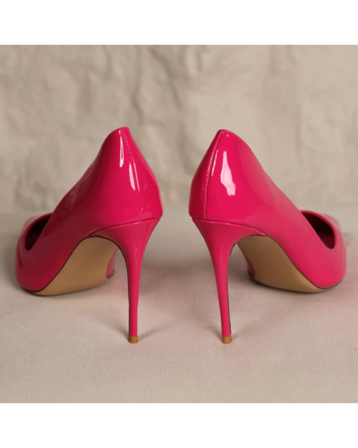 Bright pink patent leather stiletto pumps with pointed toes and high heels on neutral background — Subashini Heels | Endless UAE