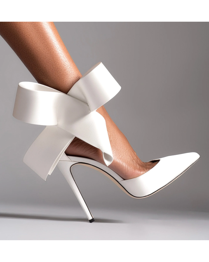 White pointed-toe stiletto heel pump with sculptural oversized bow ankle wrap detail — Aminah Abdul Jillil | Endless UAE
