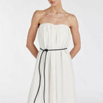 Elegant cream strapless midi dress with black tie belt and side pockets, featuring gathered bodice and flowing silhouette — Dissh | Endless UAE