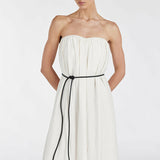 Elegant cream strapless midi dress with black tie belt and side pockets, featuring gathered bodice and flowing silhouette — Dissh | Endless UAE