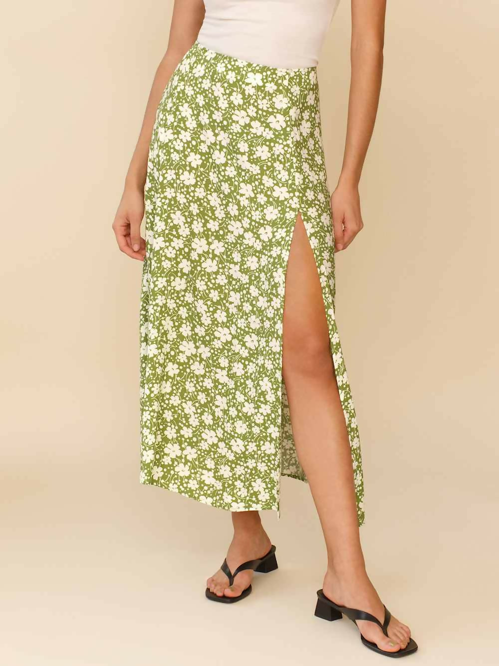 Woman wearing white sleeveless tank top and green floral midi skirt with side slit — Endless | Endless UAE