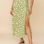 Woman wearing white sleeveless tank top and green floral midi skirt with side slit — Endless | Endless UAE