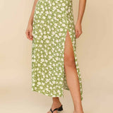 Woman wearing white sleeveless tank top and green floral midi skirt with side slit — Endless | Endless UAE