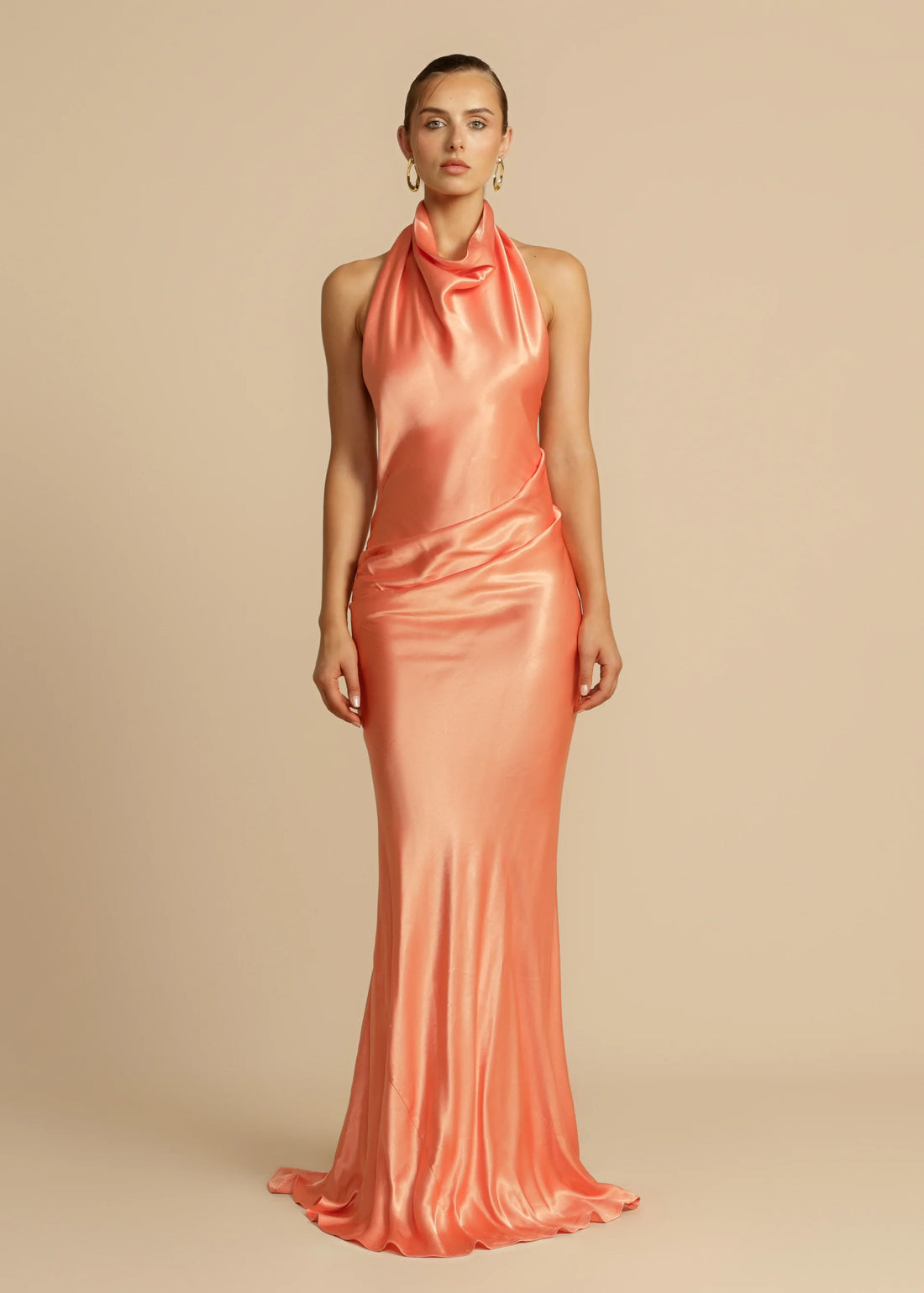 Elegant coral silk satin halter neck gown with draped neckline and flowing silhouette — Arcina Ori | Endless UAE