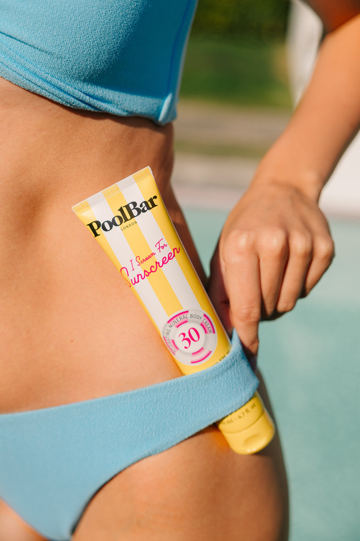 Yellow tube of PoolBar London SPF 30 mineral sunscreen with pink circular badge and striped design — PoolBar London | Endless UAE