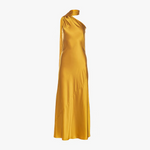 Woman wearing golden yellow silk slip dress standing on rocks by the sea — Vasiliki | Endless UAE