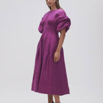 Woman wearing Adelie Puff Sleeve Midi Dress in plum with black strappy sandals — Aje | Endless UAE