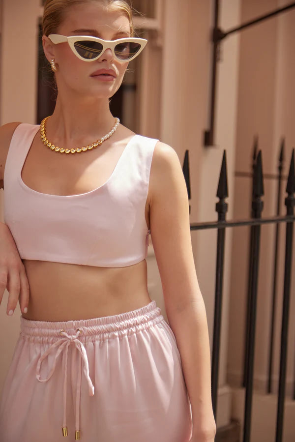 Woman wearing white sculpted bralette with cat-eye sunglasses and gold necklace outdoors — By Keara | Endless UAE