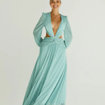 Woman wearing a flowing light blue wrap dress with long sleeves and cutout waist detail — Anne Louise Boutique | Endless UAE