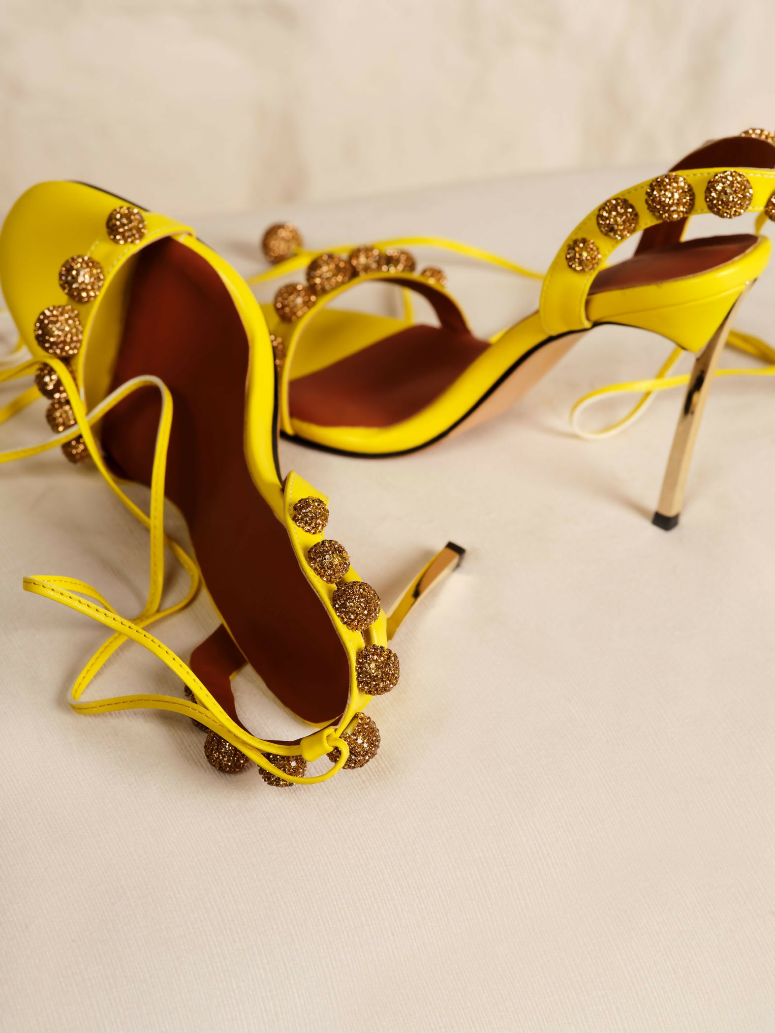 Bright yellow strappy high heel sandals with gold embellished details along the straps — Subashini Heels | Endless UAE