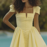 Woman wearing yellow off-shoulder mini dress with puffed sleeves by poolside — Endless | Endless UAE